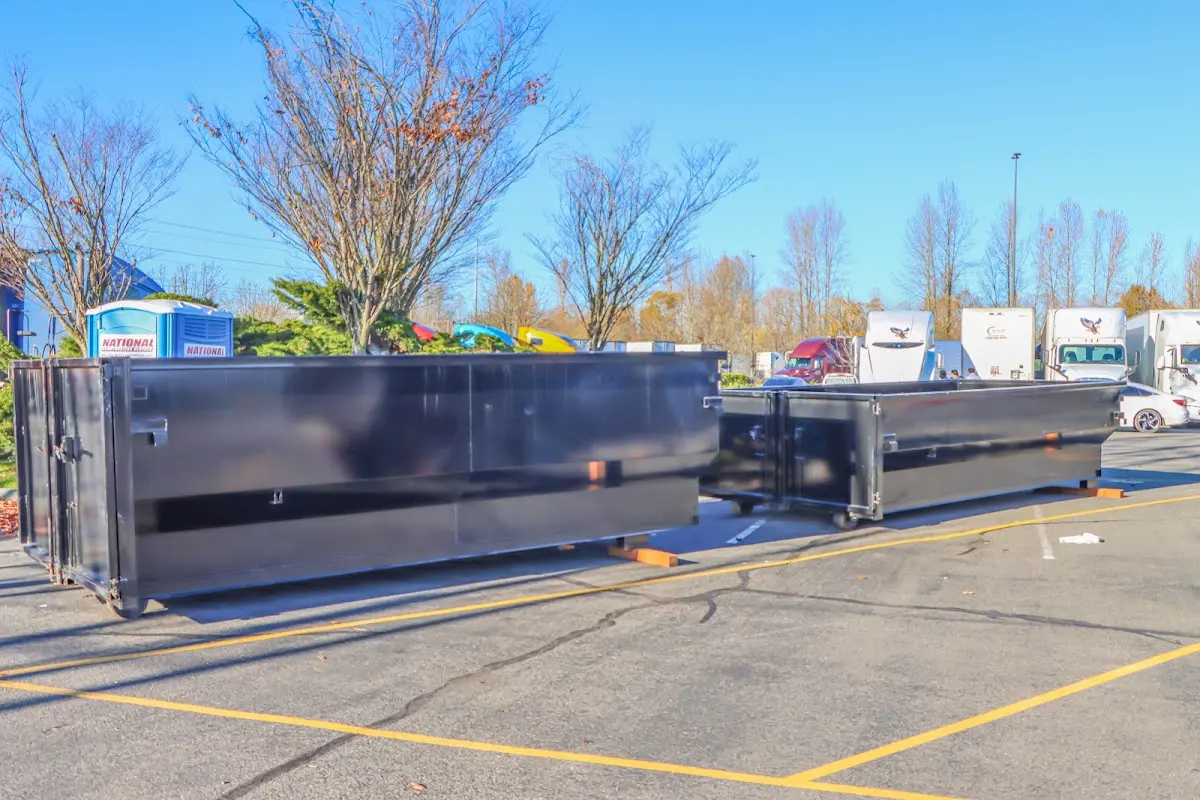 Professional dumpster rental service with roll-off container on residential driveway in Wendell